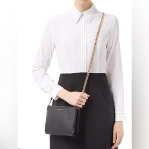 Addict pochette by Sandro in beautiful dark brown color